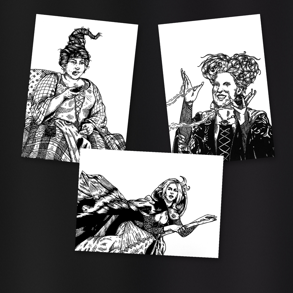 Sanderson Sisters print set — original Sarah, Mary, and Winnie artwork tilted and overlapping on a charcoal gray background